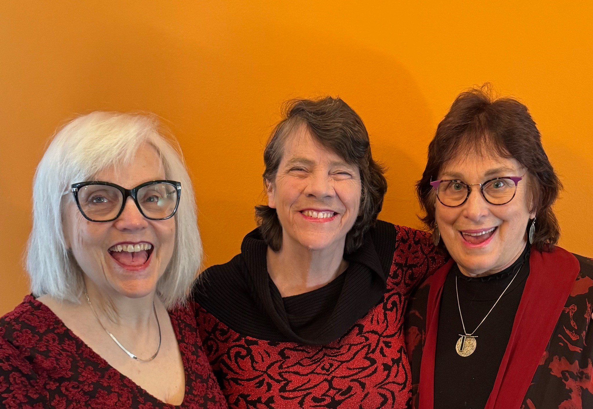 Claire, Gail, Karen orange backdrop